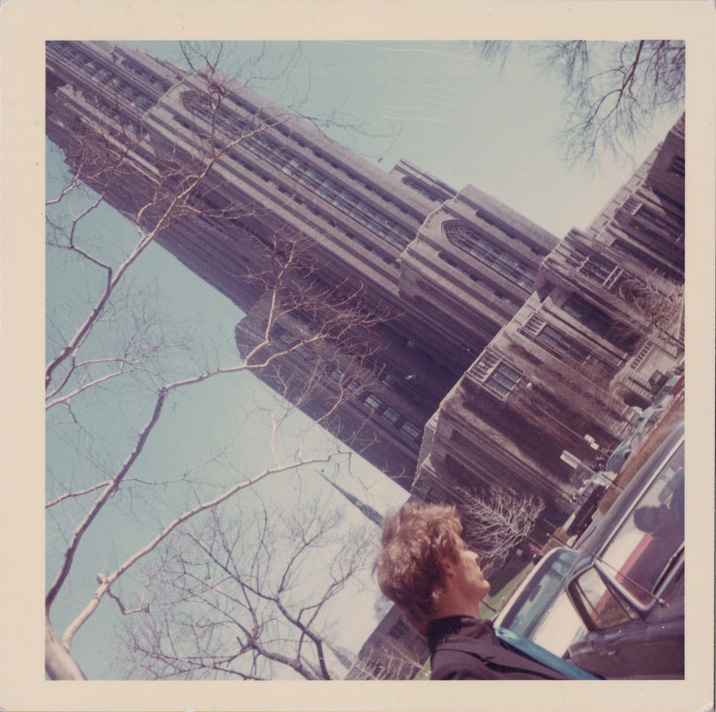 Man stands next to car across from woman.
